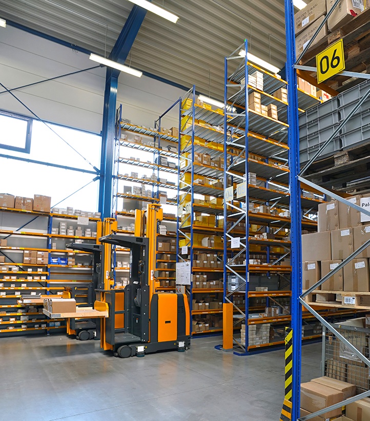 Forklift moving boxes in warehouse — service logistics